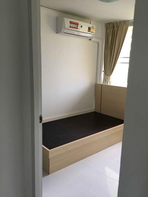 Small bedroom with bed frame and air conditioner