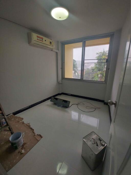 Small bedroom with a window and air conditioning unit