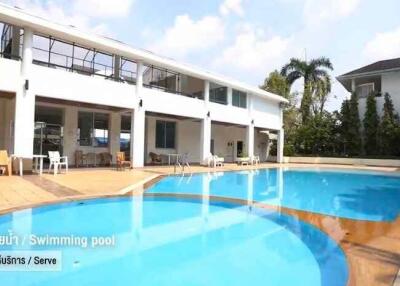 Outdoor swimming pool with surrounding seating area