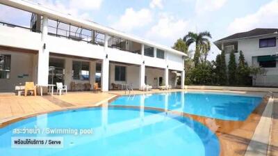 Outdoor swimming pool with surrounding seating area