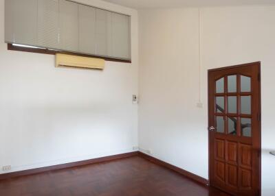 Empty room with wooden floor and door