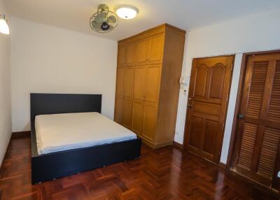 Bedroom with wooden floors and ample storage