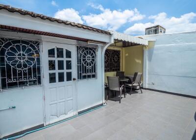 Outdoor patio area with seating and ornamental doors