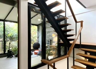 Modern staircase with wooden steps and black railings