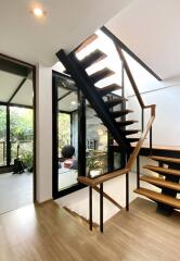 Modern staircase with wooden steps and black railings