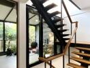 Modern staircase with wooden steps and black railings