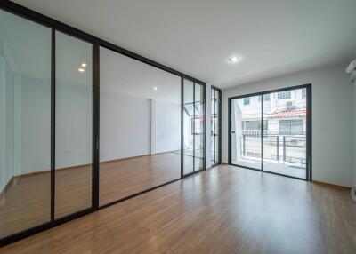 Modern living room with large glass doors and wooden flooring