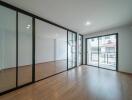 Modern living room with large glass doors and wooden flooring