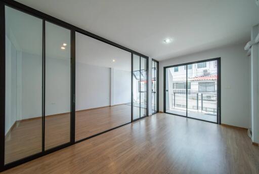 Modern living room with large glass doors and wooden flooring