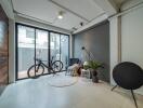 Modern living room with large windows, plants, and a bicycle