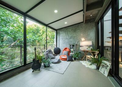 Bright and modern living room with large windows and greenery view