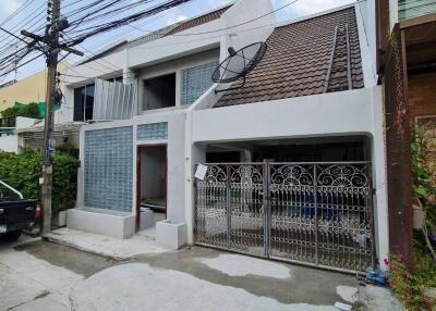 Two-story house exterior with gated entrance