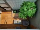 Aerial view of a cozy balcony with wooden flooring and greenery