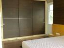 Modern bedroom with a large bed and built-in wardrobe