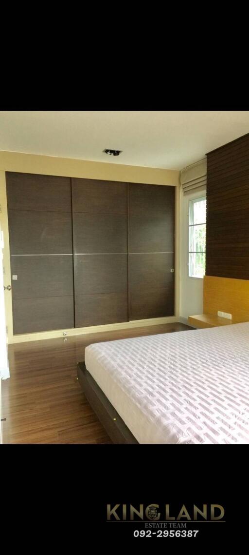 Modern bedroom with a large bed and built-in wardrobe