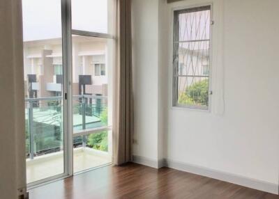 empty bedroom with large windows and wooden floor