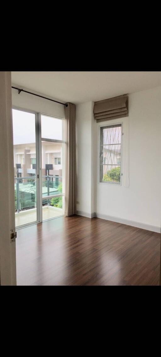 empty bedroom with large windows and wooden floor