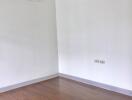 Empty bedroom with hardwood floors and air conditioning unit