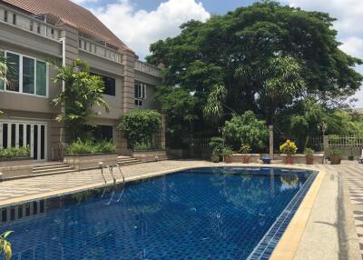 Outdoor swimming pool view with building in background