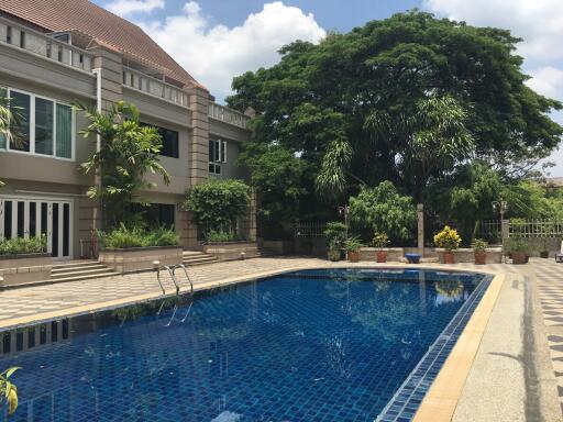 Outdoor swimming pool view with building in background