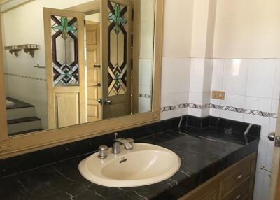 Bathroom with large mirror and sink