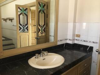 Bathroom with large mirror and sink