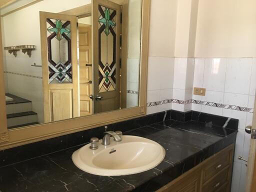 Bathroom with large mirror and sink