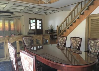 Spacious dining area with a large wooden table and upholstered chairs