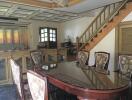 Spacious dining area with a large wooden table and upholstered chairs