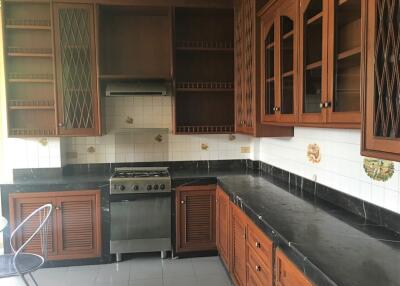 Spacious wooden kitchen with tiled backsplash and modern appliances