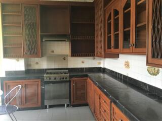 Spacious wooden kitchen with tiled backsplash and modern appliances