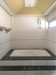 Bathroom with bathtub and shelves