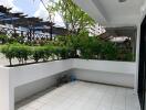 Covered outdoor patio with plants.