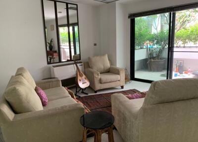 Cozy living room with large glass door and garden view