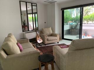 Cozy living room with large glass door and garden view