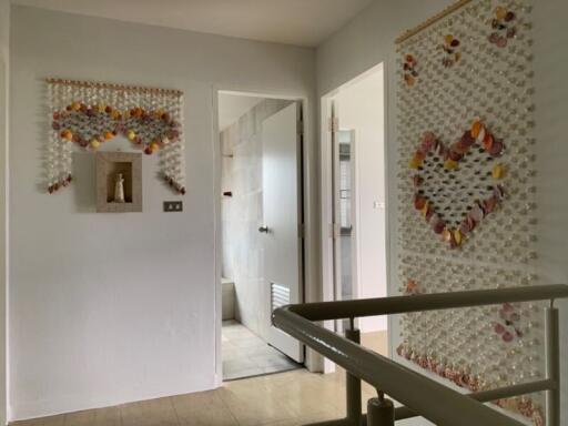 Hallway with decorative wall hangings