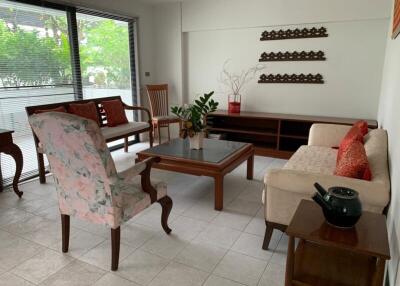 Bright living room with large windows and modern furniture