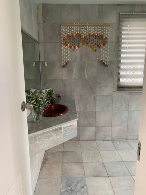 Bathroom with tiled walls and sink