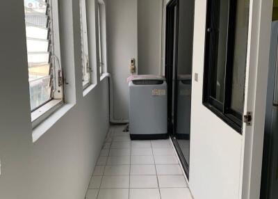 Utility or laundry room with washing machine and windows