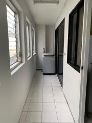 Utility or laundry room with washing machine and windows