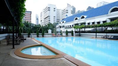 Outdoor pool area with view of surrounding buildings