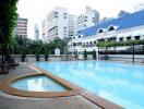 Outdoor pool area with view of surrounding buildings