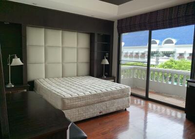 Spacious bedroom with large window and balcony