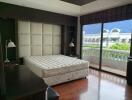 Spacious bedroom with large window and balcony