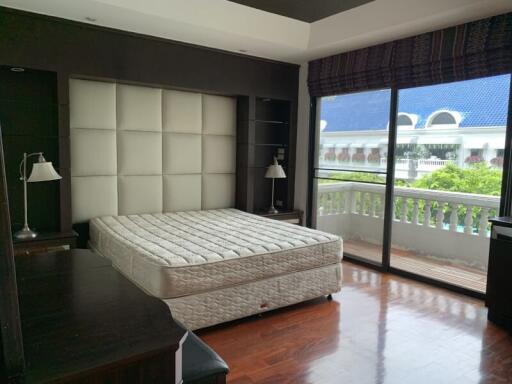 Spacious bedroom with large window and balcony