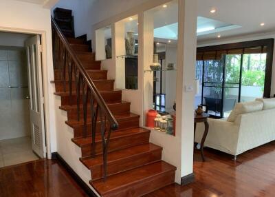 Living room with staircase and open space to a seating area