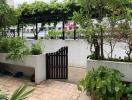 Outdoor garden area with gate and plants