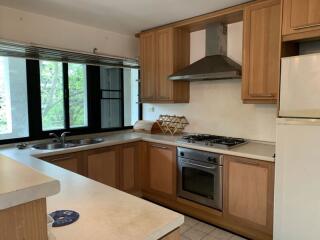 Modern kitchen with wooden cabinets and stainless steel appliances