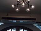 Modern ceiling light fixture with an air conditioning unit and an arched window