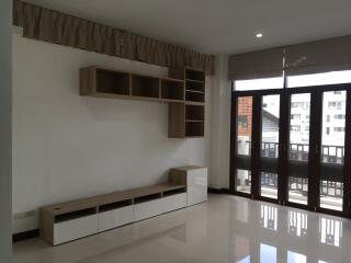 Minimalist living room with large windows and modern shelving unit